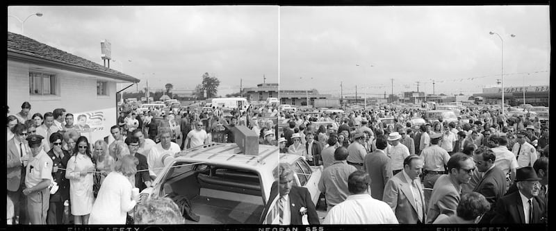 People mill around a shopping centre car park in Laurel, Maryland, after an assassination attempt on Alabama Governor George Wallace, who was campaigning for president (J Bowman/AP)