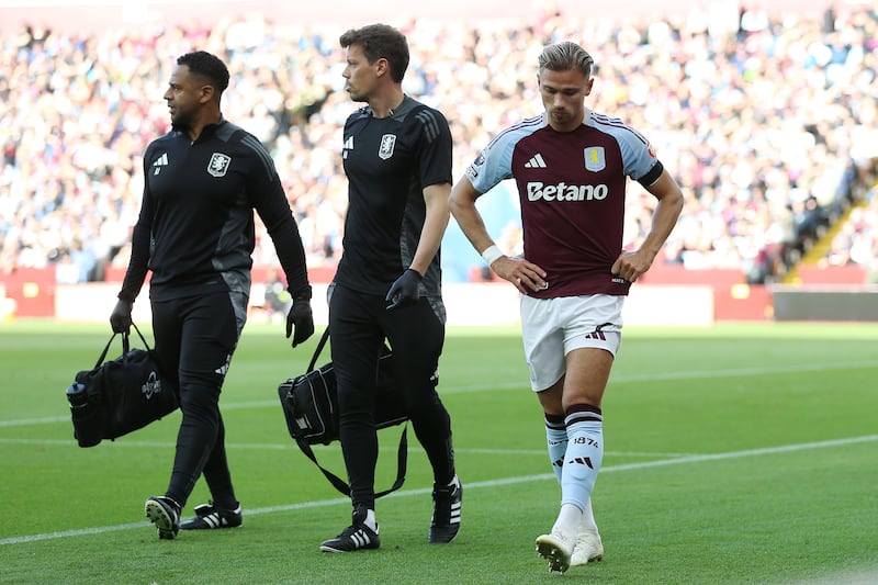 Matty Cash, right, leaves the pitch injured