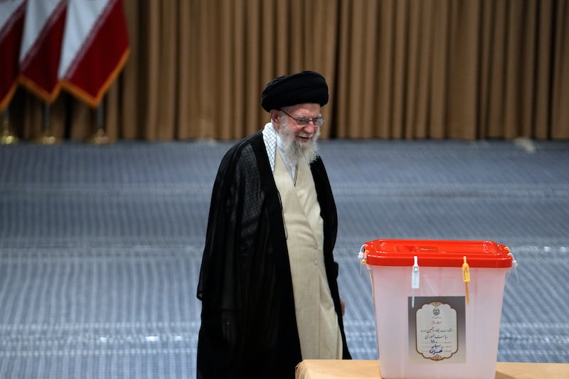 Iranian Supreme Leader Ayatollah Ali Khamenei walks towards the ballot box (Vahid Salemi/AP)