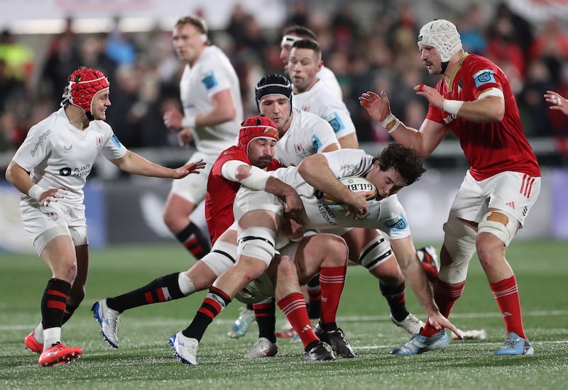 Ulster Rugby's David McCann being brought to ground by Munster's John Hodnett