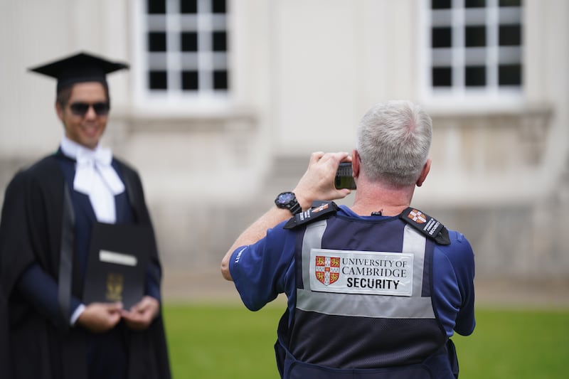 Security officers allowed new graduates into the yard at Senate House for photographs after the protesters left