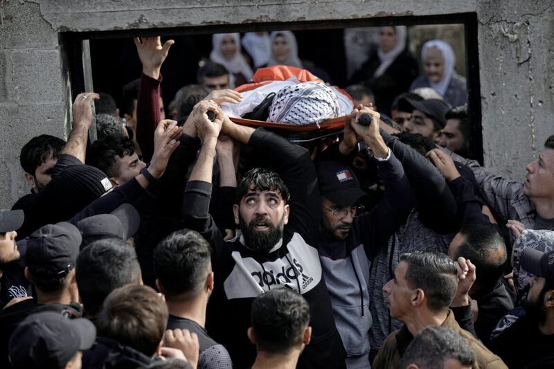Mourners carry the body of Mahmoud Abu Haniyeh (17) during his funeral at the town of Azzun in the West Bank. The Palestinian Health Ministry said Abu Haniyeh was killed during clashes with the Israeli army on Saturday 