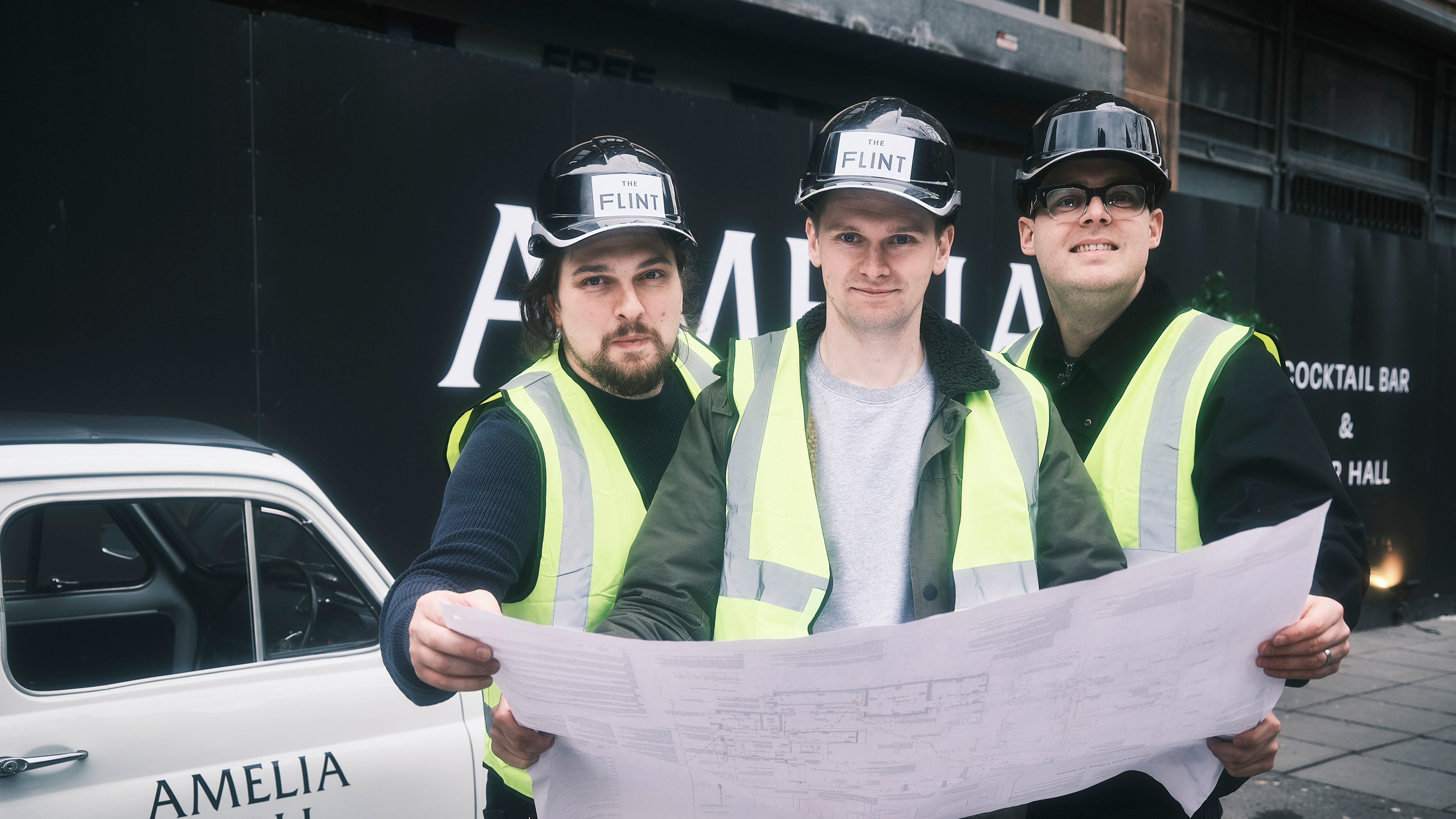 L-R: Ben Ringland, Peter Ringland and Thomas Camblin examine the plans for their new Amelia Hall hospitality project in Belfast city centre.