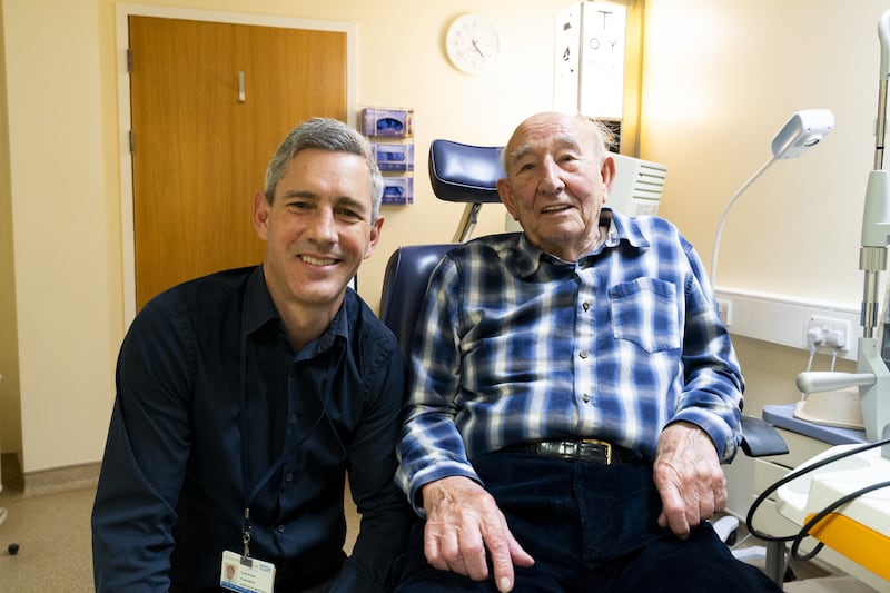 Mr Thomas Poole, consultant ophthalmologist at Frimley Health NHS Foundation Trust, with patient Cecil Farley