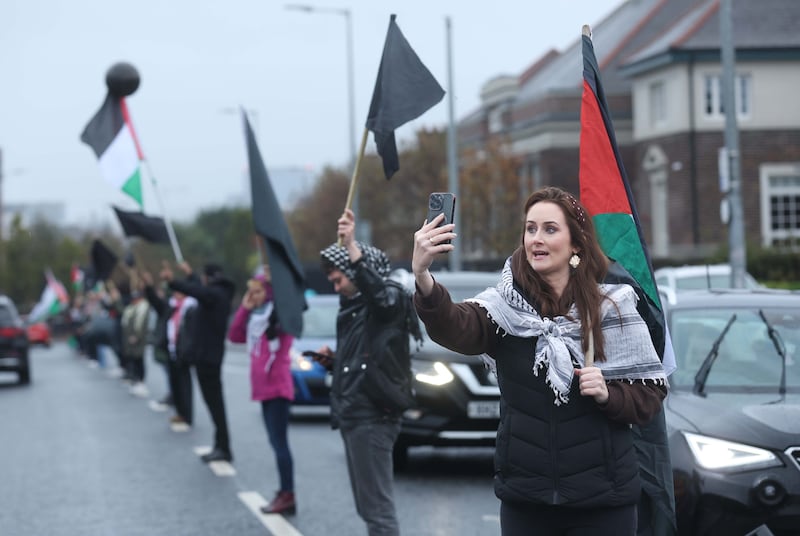 Supporters of the Palestinian people hold a black flag protest at the Murals on the Falls Road in West Belfast.
PICTURE COLM LENAGHAN