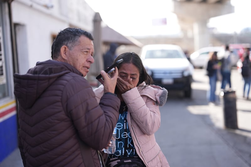 Marcela Medina and her husband Enrique Corea of Venezuela react to seeing that their appointment was cancelled as they wait near the border crossing in Tijuana (Gregory Bull/AP)