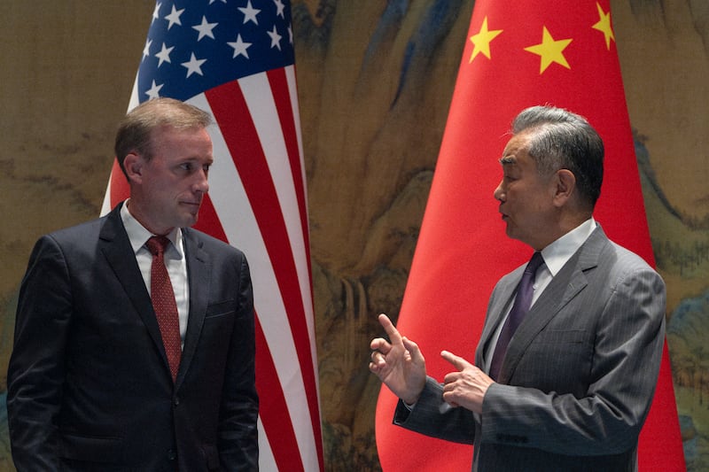 Wang Yi, right, the director of the Communist Party’s Central Foreign Affairs Commission Office speaks to White House national security adviser Jake Sullivan, left, before their talk at Yanqi lake in Beijing (AP Photo/Ng Han Guan, Pool)