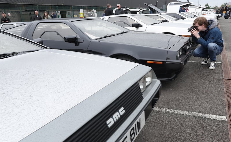 DeLorean owners gather at the Cutts in Dunmurry on Sunday as they drive on the old test track as part of the DeLorean Revival in Belfast.
PICTURE COLM LENAGHAN