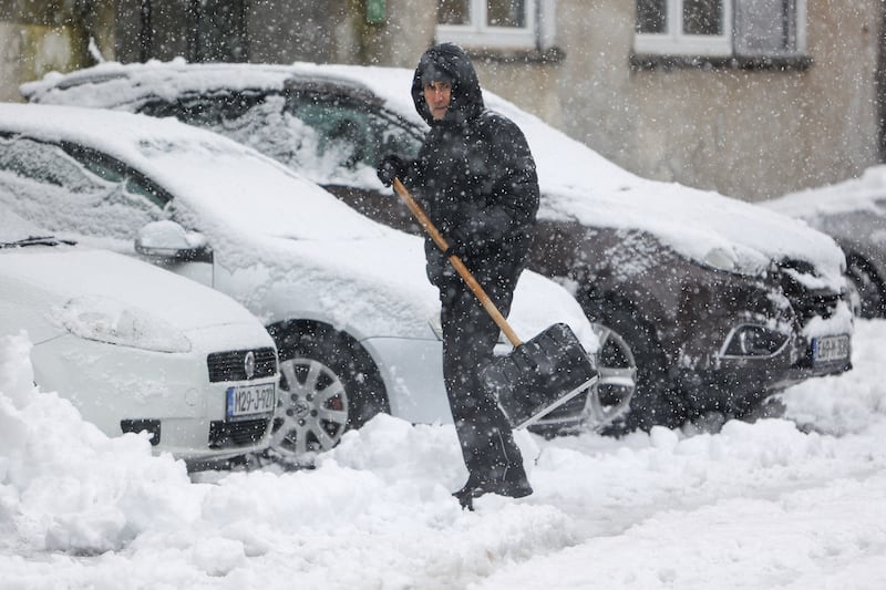 A man shovels snow from the street in Bihac, Bosnia (Edvin Zulic/AP)