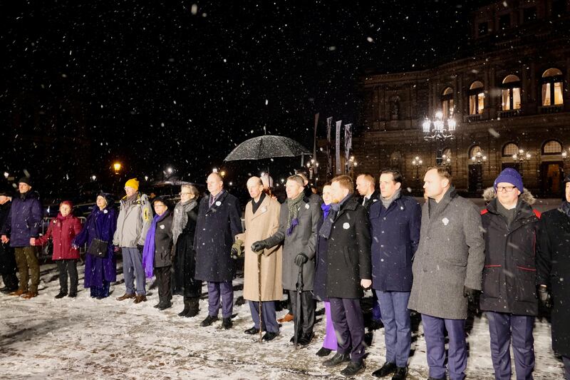 The Duke of Kent holds hands as part of a human chain by the people of Dresden in remembrance