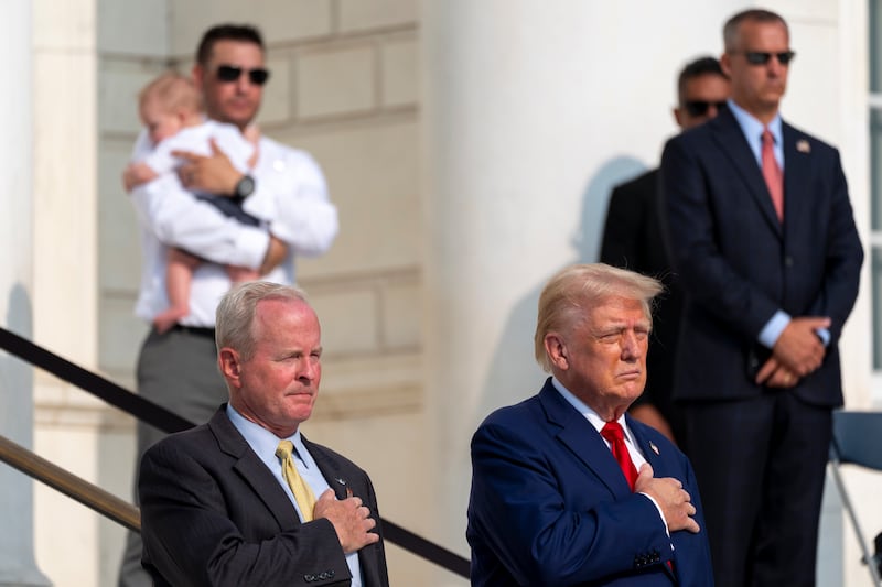 Bob Quackenbush, deputy chief of staff for Arlington National Cemetery, and Donald Trump at the Tomb of the Unknown Solider (Alex Brandon/AP)