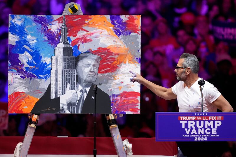 Scott Lobaido unveils a painting before Republican presidential nominee former president Donald Trump speaks at the campaign rally (Evan Vucci/AP)