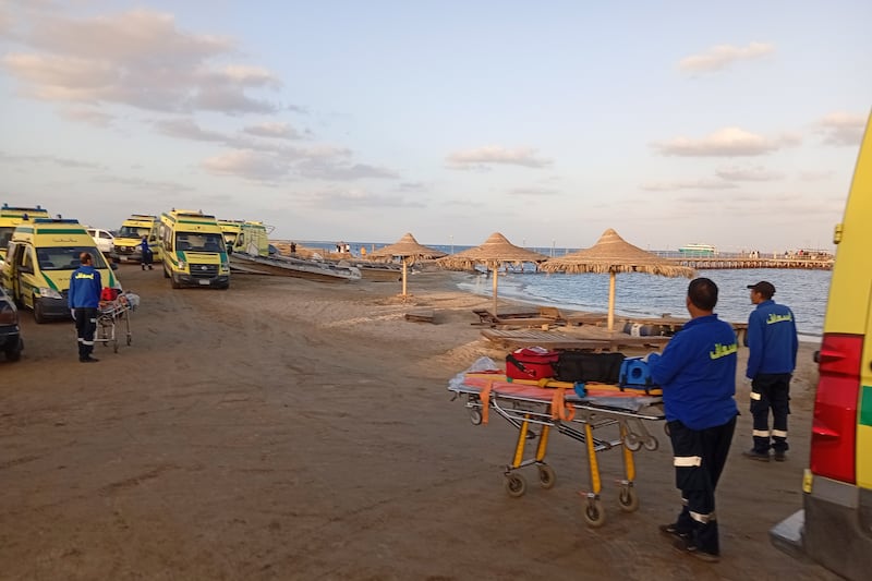 Rescuers wait on the beach of Marsa Alam, Egypt, after a tourist yacht sank in the Red Sea (AP)