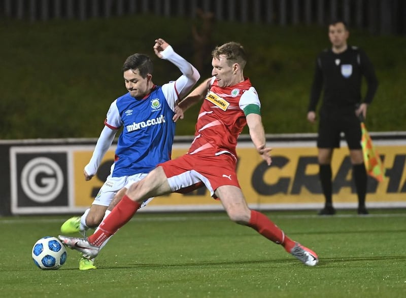 Cliftonville&rsquo;s Chris Curran  and Linfield&rsquo;s Jordan Stewart  during the Co Antrim Shield semi-final at Solitude on Tuesday night<br />Picture: Colm Lenaghan/ Pacemaker&nbsp;