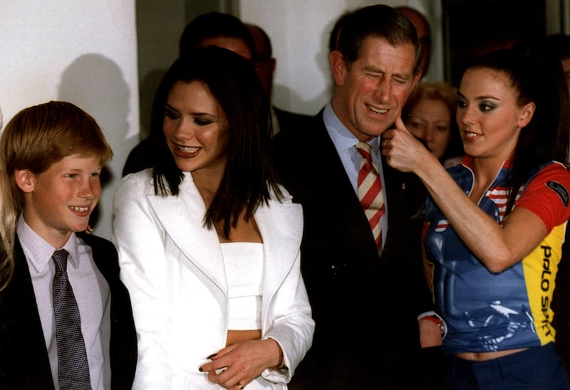 Prince Harry poses with ‘Posh Spice’ and the then-Prince of Wales before the Spice Girl’s concert in Johannesburg