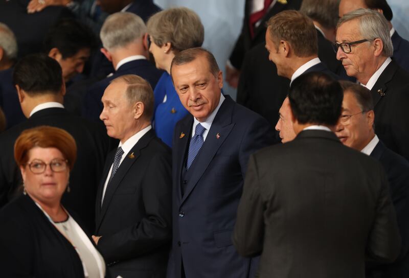 Turkish President Recep Tayyip Erdogan (centre) and Russian President Vladimir Putin (left) arrive for a family photo with other world leaders during the G20 summit in Hamburg in 2017