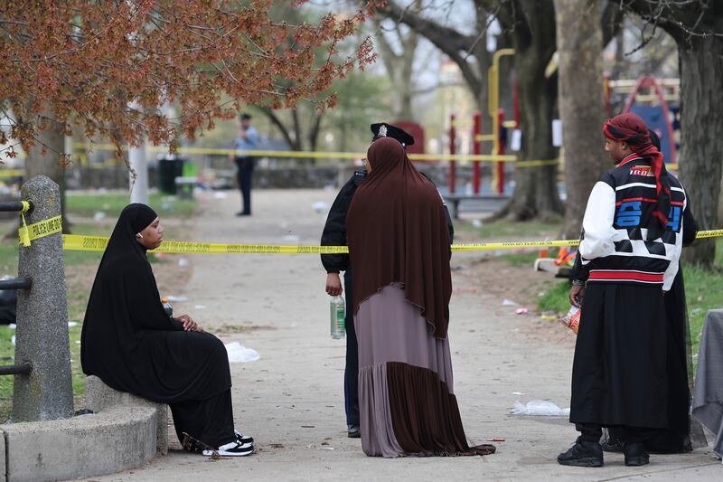 People speak to police following a shooting at an Eid al-Fitr event in Philadelphia (Monica Herndon/The Philadelphia Inquirer via AP)