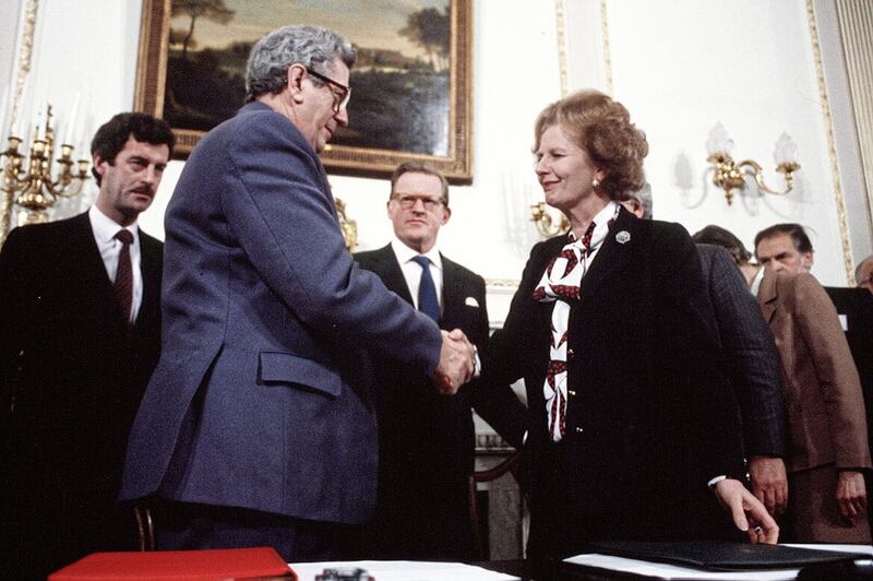 Secretary of State Tom King (centre) and T&aacute;naiste Dick Spring look on as Margaret Thatcher and Garrett Fitzgerald sign the Anglo-Irish Agreement in 1985 