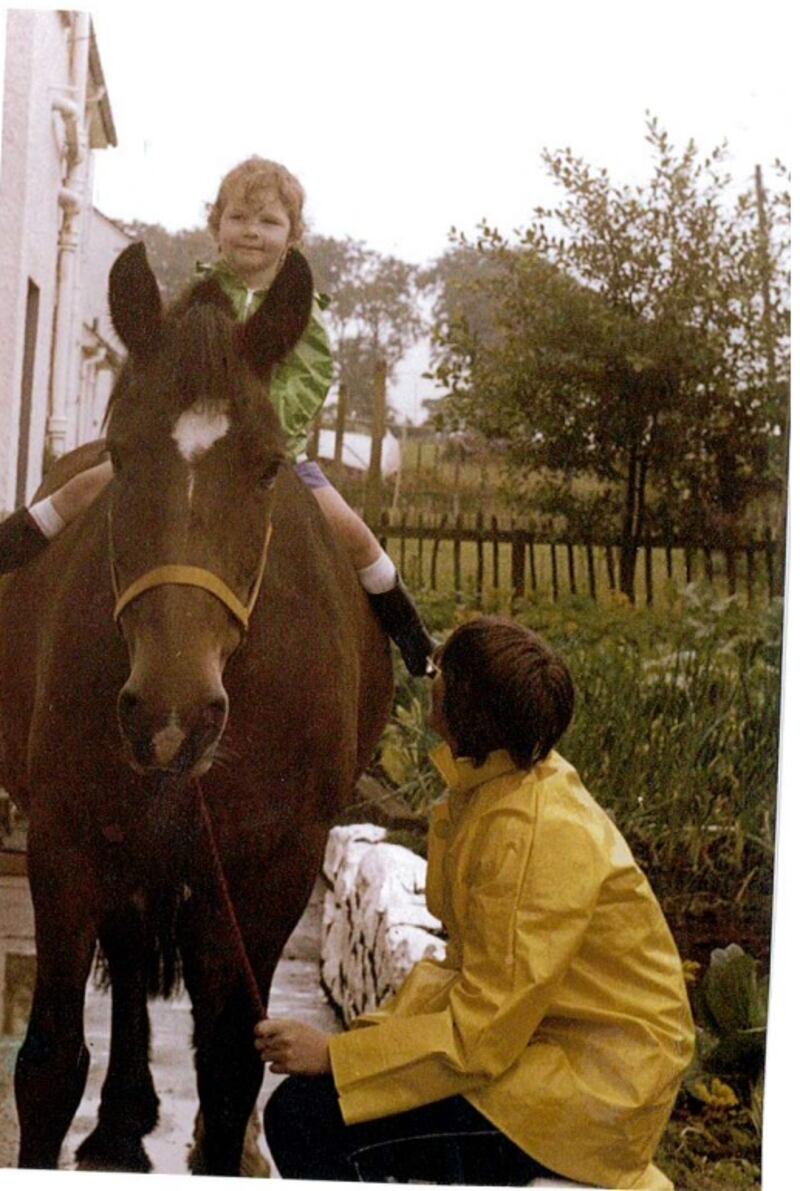 Emma Caldwell riding a horse as a young child