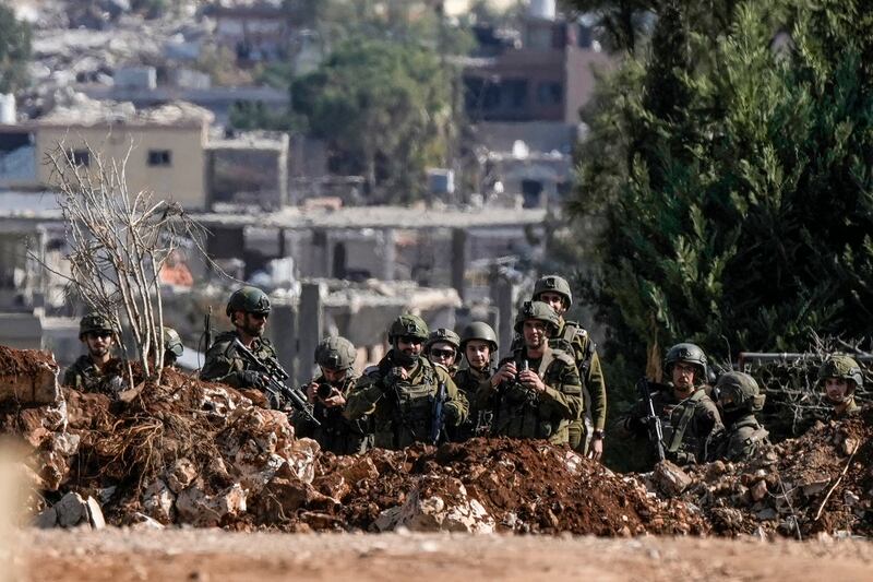 Israeli soldiers take a position to block a road in the southern Lebanese village of Aitaroun (Bilal Hussein/AP)