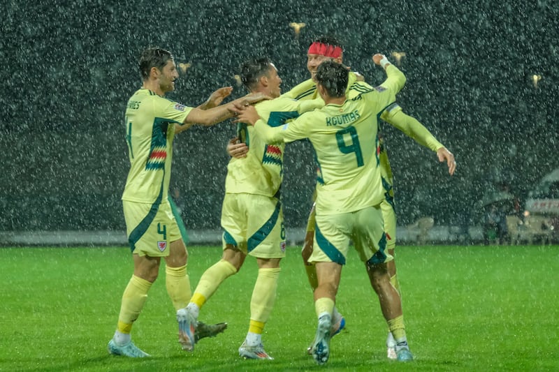 Wales players celebrate Kieffer Moore’s first-minute strike in their Nations League win in Montenegro (Risto Bozovic/AP)