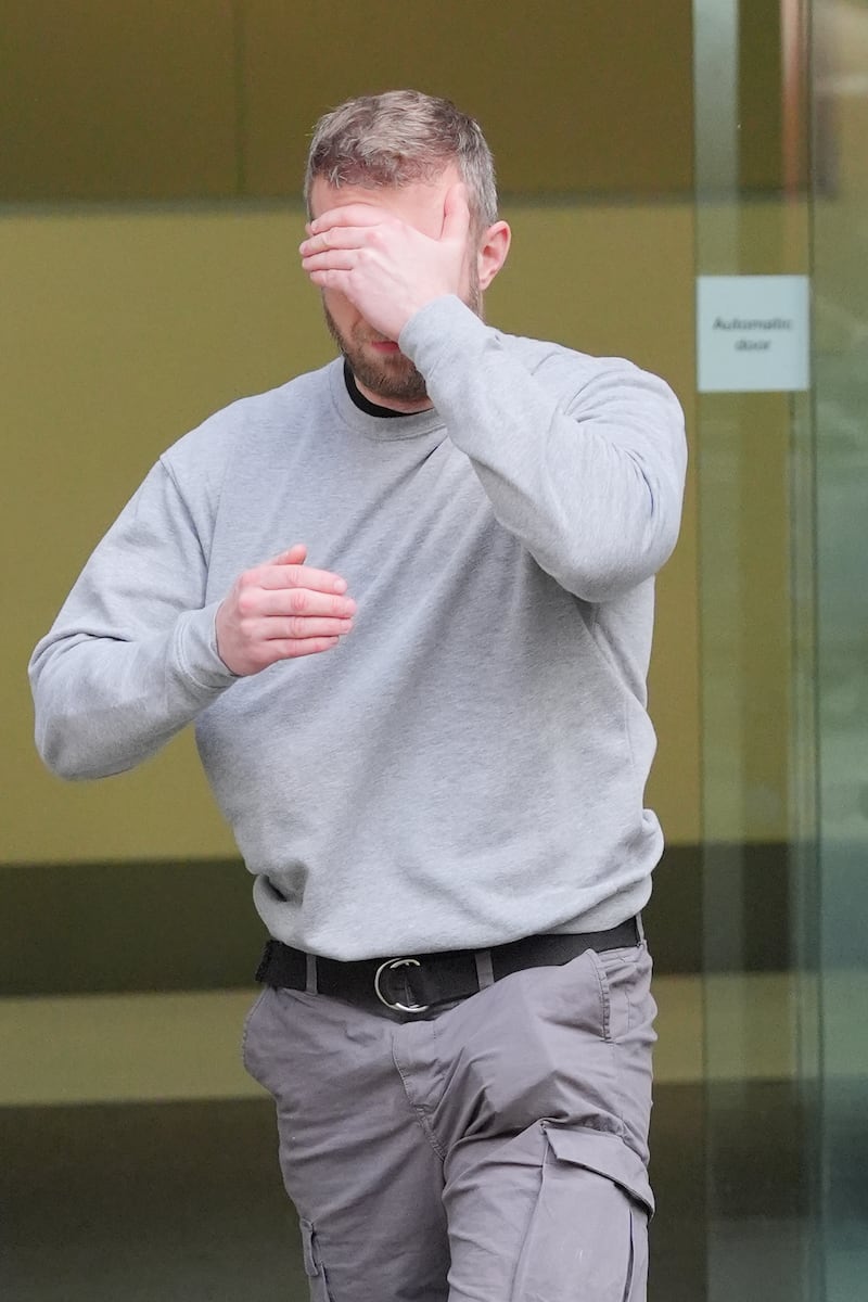 Matthew Trickett covers his face as he leaves Westminster Magistrates’ Court