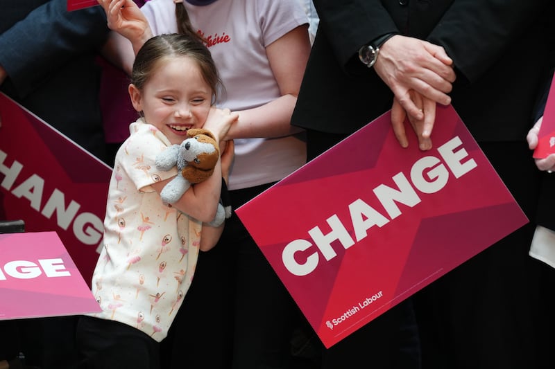 A young supporter awaits Labour leader Sir Keir Starmer for a campaign event in Glasgow