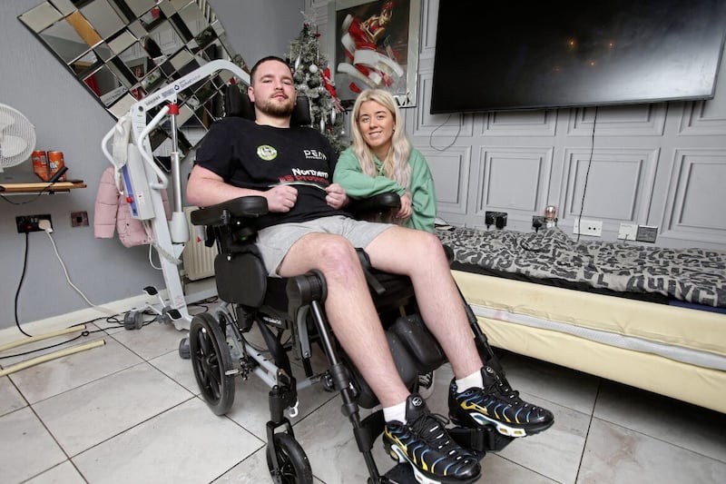  Stephen McMullan with his fiancee Aimee Fitzsimons at home in north Belfast. Stephen proposed on August 8 this year, 10 years to the day after they first got together. Picture by Mal McCann 