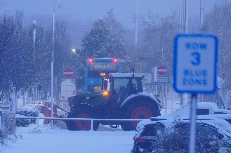 A tractor clears snow at Liverpool John Lennon Airport in Liverpool. PICTURE: PETER BYRNE/PA