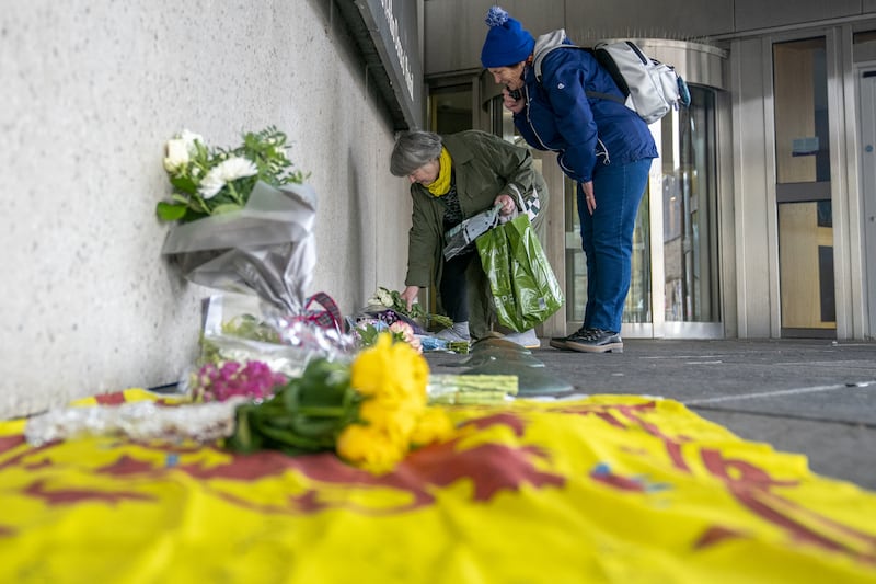 Members of the public left floral tributes outside the Scottish Parliament in Edinburgh after news of Mr Salmond’s death