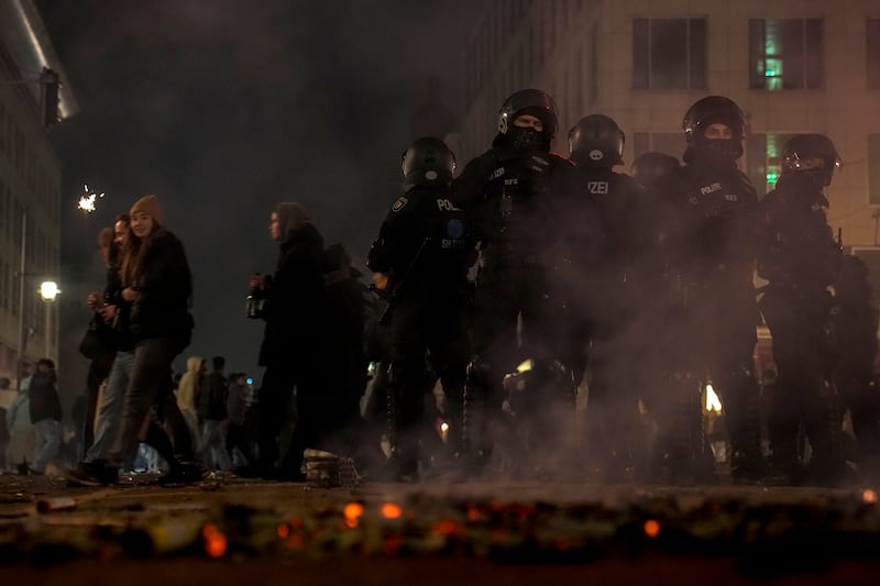 Police officers stand guard in Berlin after violence flared during New Year celebrations (Ebrahim Noroozi/AP)