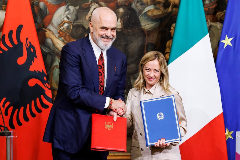 Italy’s Premier Giorgia Meloni and Albania’s Prime Minister Edi Rama shake hands after the signing of a memorandum of understanding on migrant management centres (Roberto Monaldo/AP)