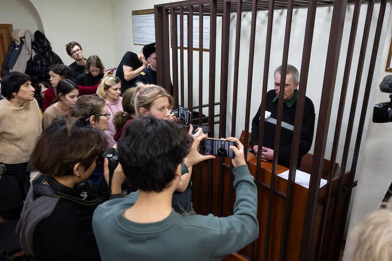 Kremlin critic Alexei Gorinov sits in a cage in the courtroom as his second trial for criticising Russia’s actions in Ukraine nears its conclusion in Vladimir, Russia (Dmitry Serebryakov/AP)