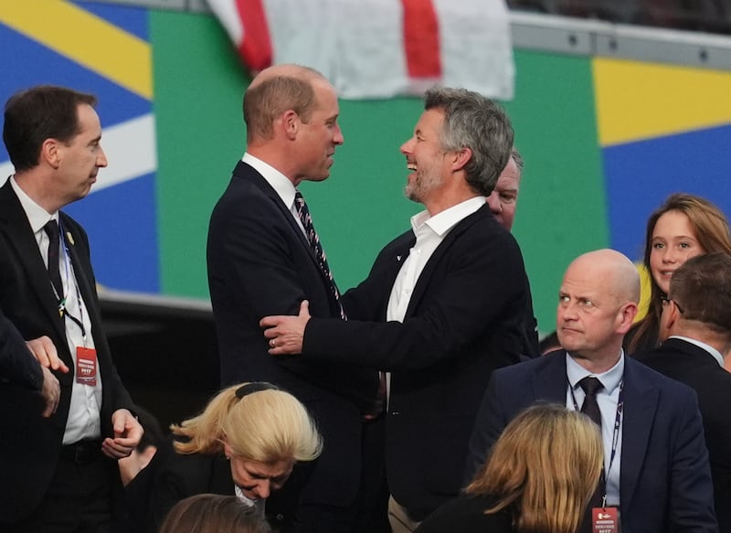 William and King Frederik X of Denmark in the stands after the match in Frankfurt