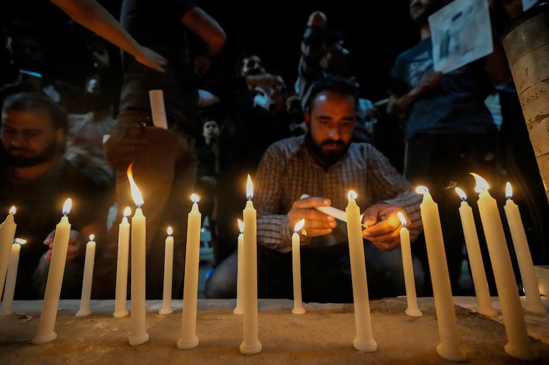 Candles are lit in memory of Mr Raisi and others killed in the helicopter crash (AP Photo/Mukhtar Khan)