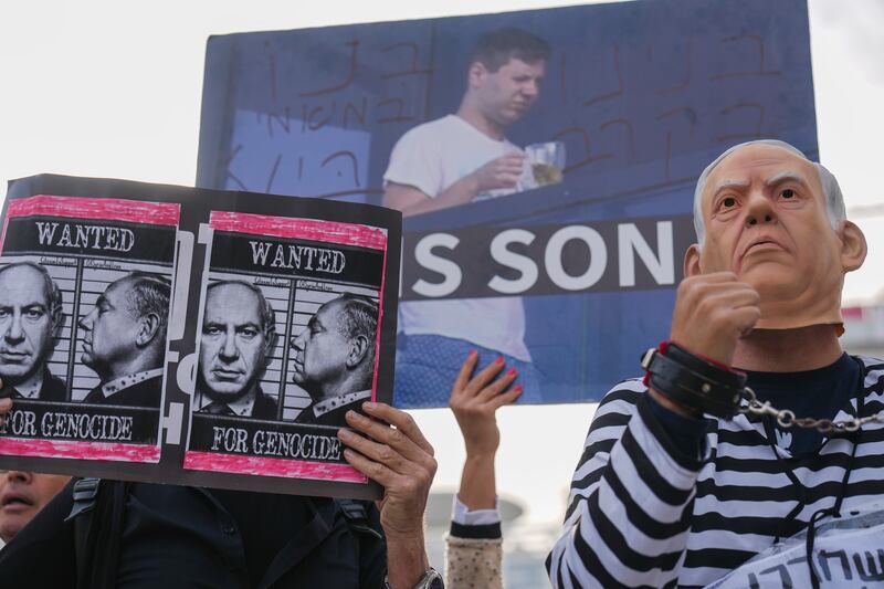 Demonstrators protest against Prime Minister Benjamin Netanyahu outside the court in Tel Aviv (Ariel Schalit/AP)