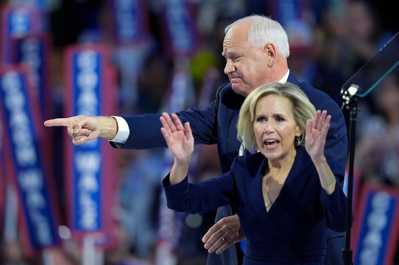 Tim Walz and wife Gwen react after his speech (Charles Rex Arbogast/AP)