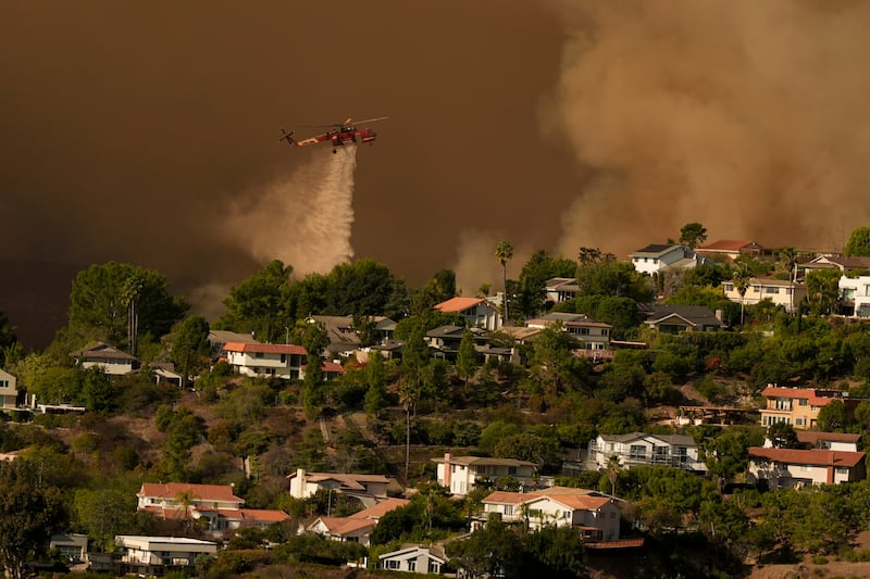 Water is dropped on homes as the Palisades Fire advances (Jae C Hong/AP)