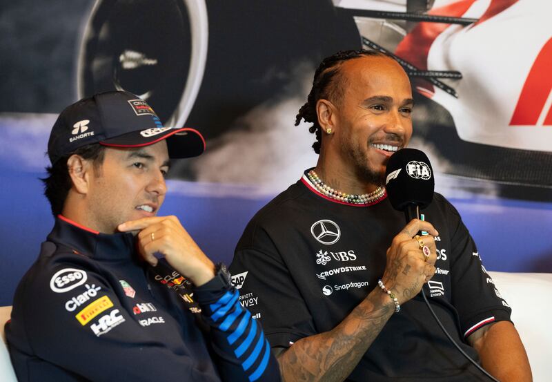 Lewis Hamilton (right) speaks at Thursday’s press conference (Christinne Muschi/The Canadian Press via AP)