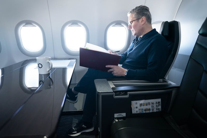 Prime Minister Sir Keir Starmer works on board a Government plane as he travels to Rio de Janeiro, Brazil to attend the G20 summit