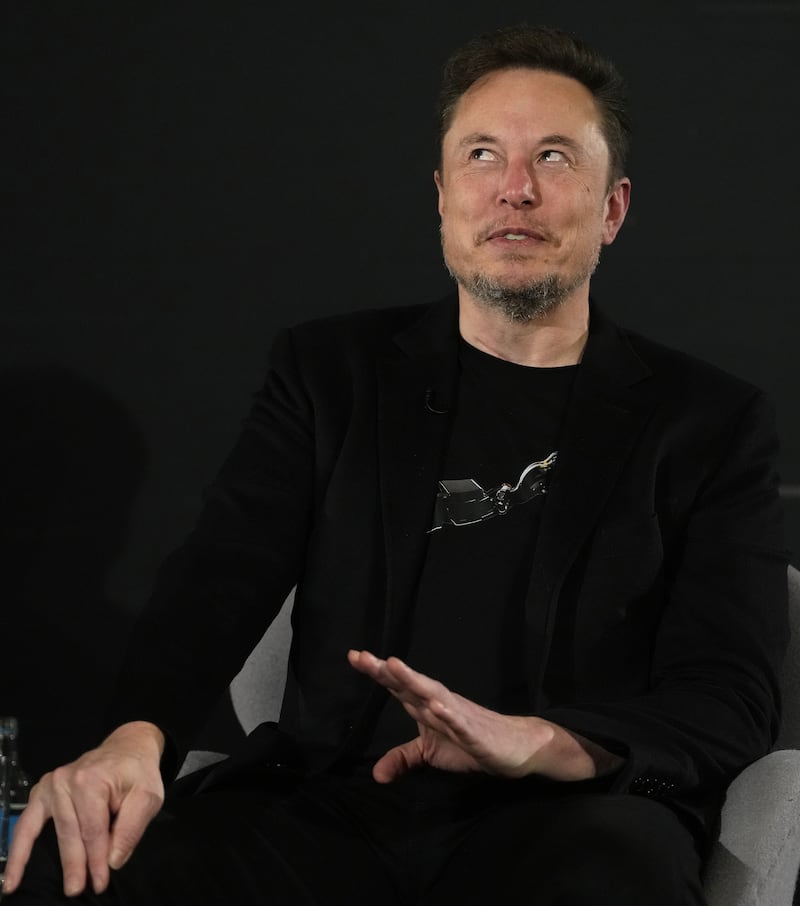 Elon Musk, CEO of Tesla and SpaceX laughs during an event in central London in 2023