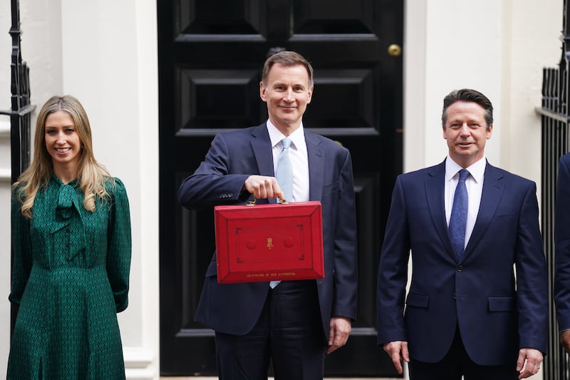 Chancellor of the Exchequer Jeremy Hunt posing with his Budget box