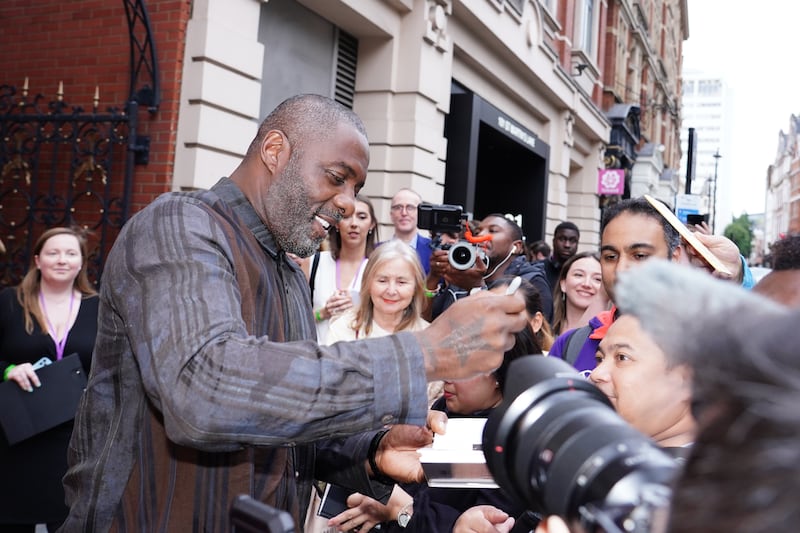 Idris Elba signs an autograph for a fan at the West End premiere of Shifters at the Duke of York’s Theatre in London