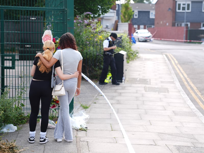 People lay flowers near to the scene