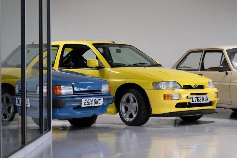 An unusual yellow Escort RS Cosworth sits beside a very familiar Fiesta