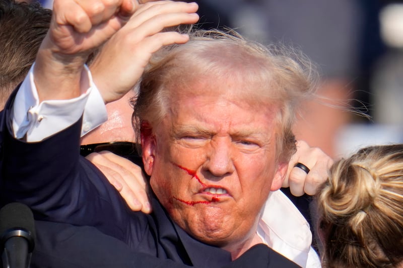 Donald Trump was left bloodied after the shooting (Gene J Puskar/AP)