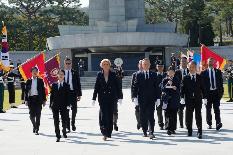 Polish President Andrzej Duda and his wife Agata Kornhauser-Duda visit the National Cemetery in Seoul, South Korea (Ahn Young-joon/AP)