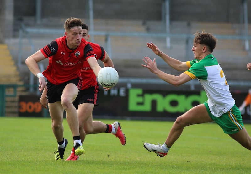 Madden's Eoin Grimley tries to evade Mullaghbawn corner-back Marty McKinstry.