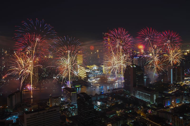 Fireworks explode over the Chao Phraya River during New Year celebrations in Bangkok (AP/Sakchai Lalit)