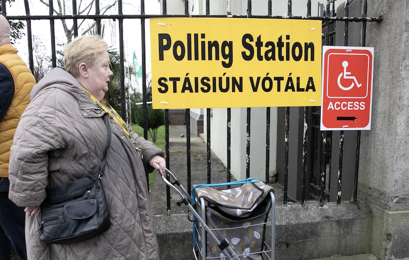 Members of the public arrive at the polling station in scoil Treasa Naofa on Donore Avenue, Dublin, on Friday